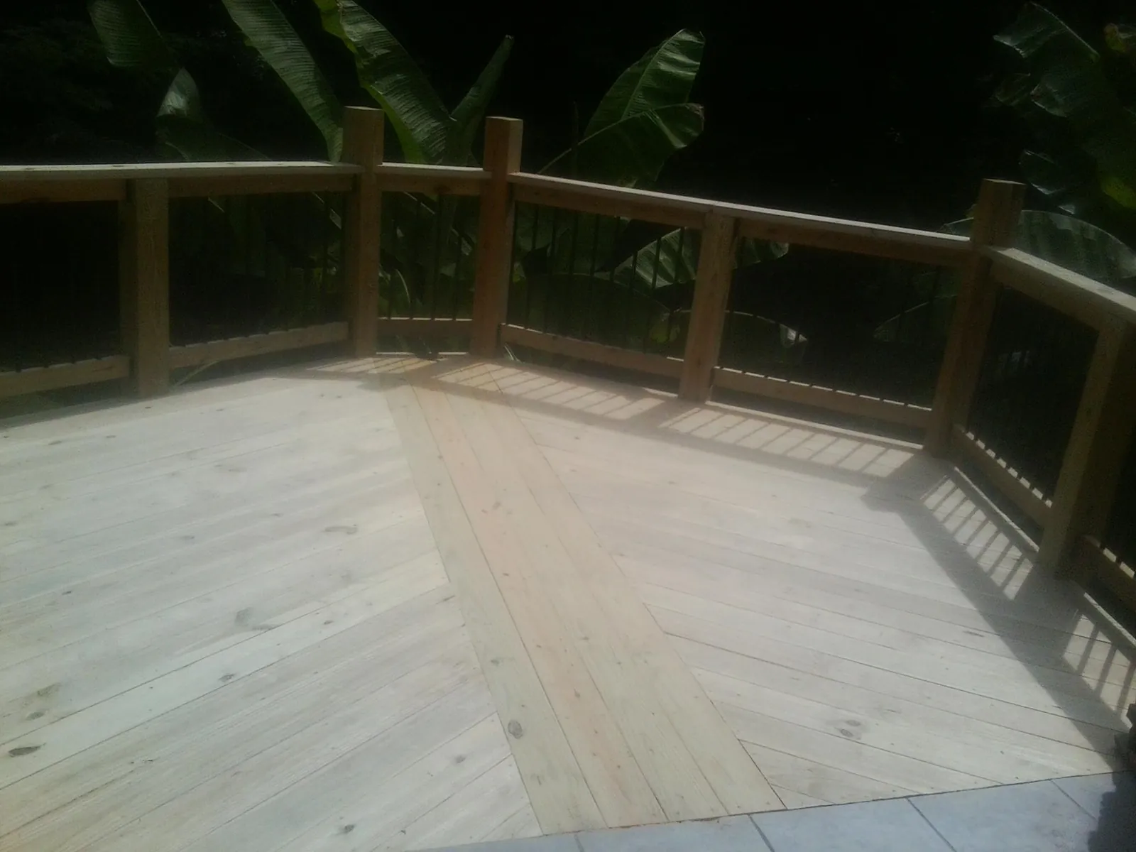 New wood deck and railing built off the back of a home in Port Republic